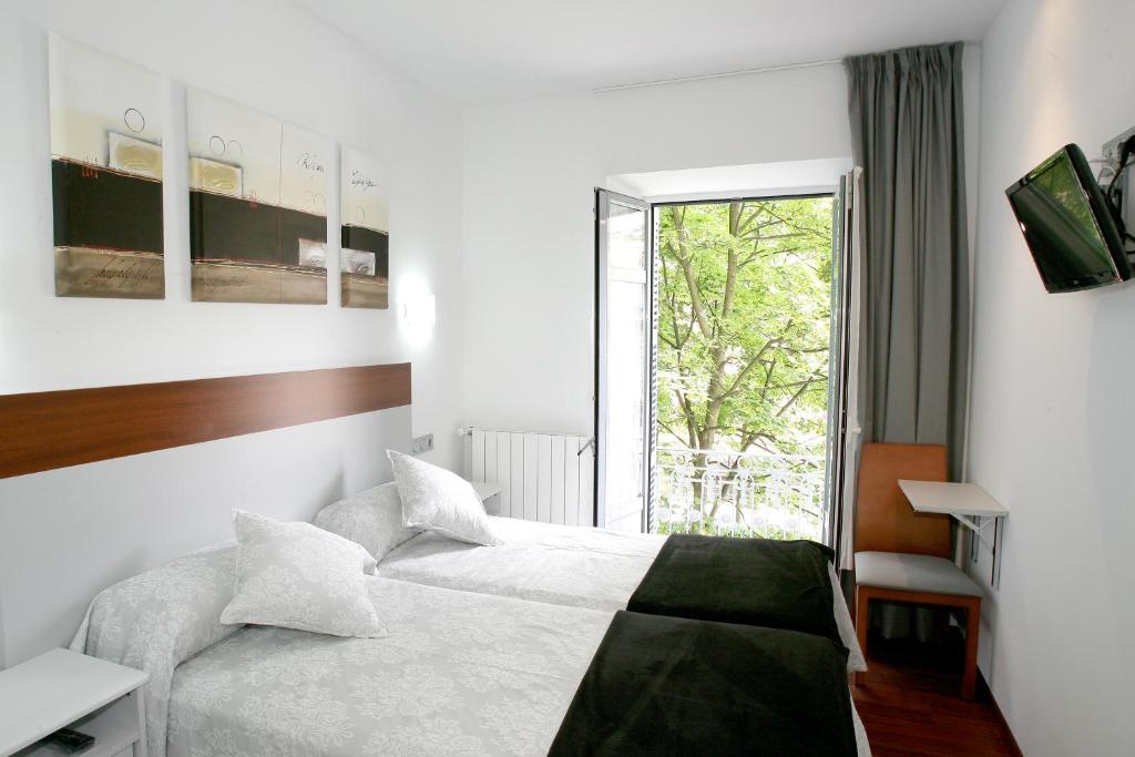 Posteľ alebo postele v izbe v ubytovaní Hostal San Ignacio Centro