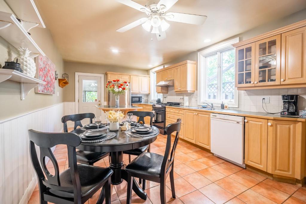a kitchen with a dining room table and chairs at Cozy 5 Bedroom House in Downtown Toronto by GLOBALSTAY in Toronto