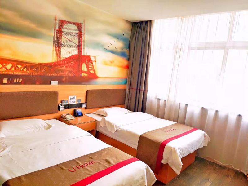 a hotel room with two beds and a large window at Thank Inn Plus Hotel Henan Luoyang Luolong University Zhang Heng Street City in Luoyang