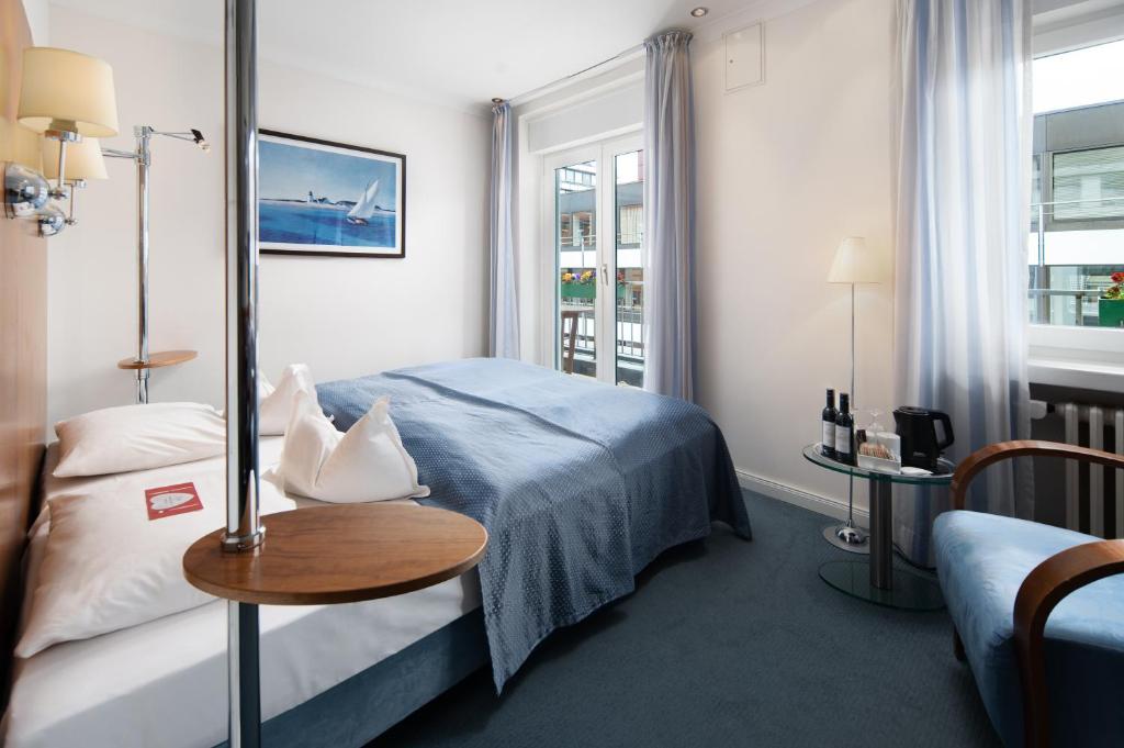 Postel nebo postele na pokoji v ubytování Hotel Baseler Hof