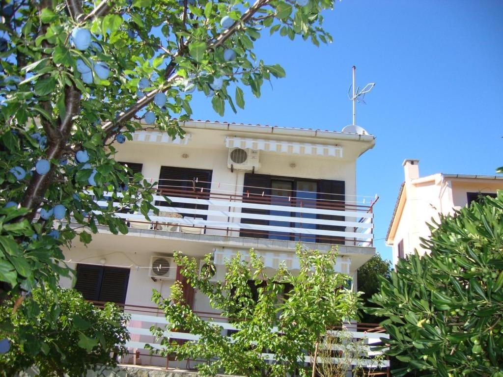 a white building with a balcony on top of it at Room in Cres with sea view, balcony, air conditioning, WiFi 4249-5 in Cres