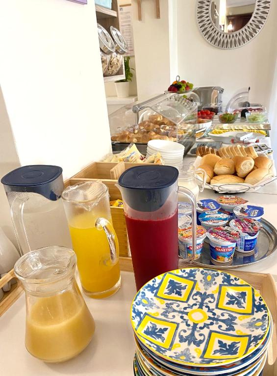 a kitchen counter with drinks and plates of food at Hotel Sylesia in Letojanni