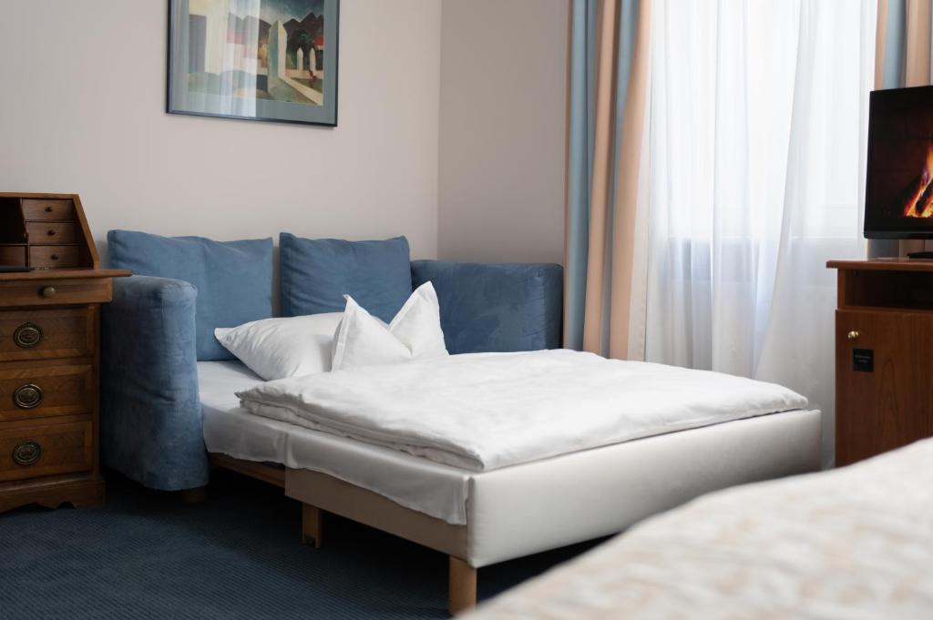 Postel nebo postele na pokoji v ubytování Hotel Baseler Hof