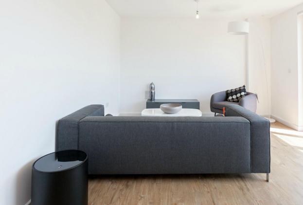 a living room with a couch and a table at The Unity in London