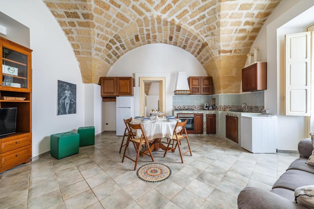 a kitchen and dining room with a table and chairs at Terra Mia In The Historic Center Of Lecce - Happy Rentals in Lecce