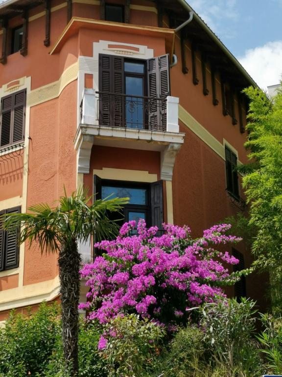 a building with pink flowers in front of it at Romeo&amp;Juliet in Opatija