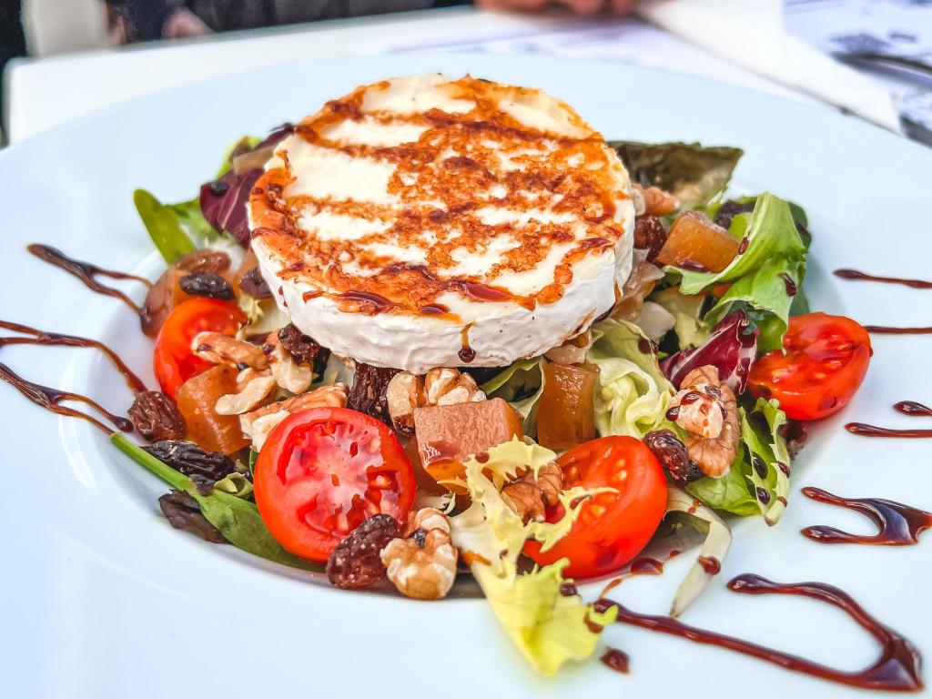 a plate of food with a salad on a white plate at Perla Marina in Nerja