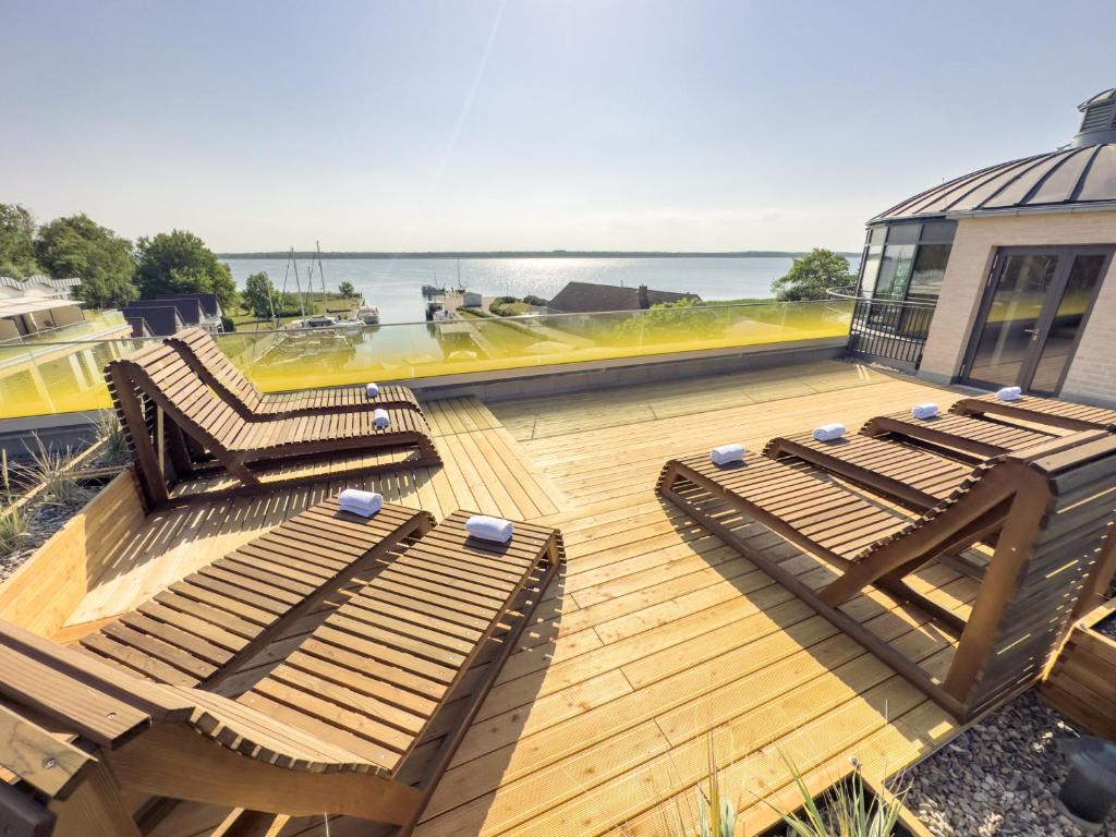 a deck with lounge chairs and a view of the ocean at Appartements "Zum Leuchtturm" Hafen Rankwitz Insel Usedom in Rankwitz