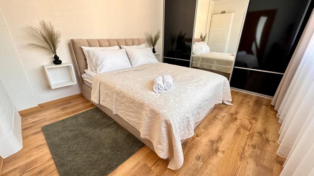 a bedroom with a bed with two towels on it at LILLE`S apartment in city center in Alūksne