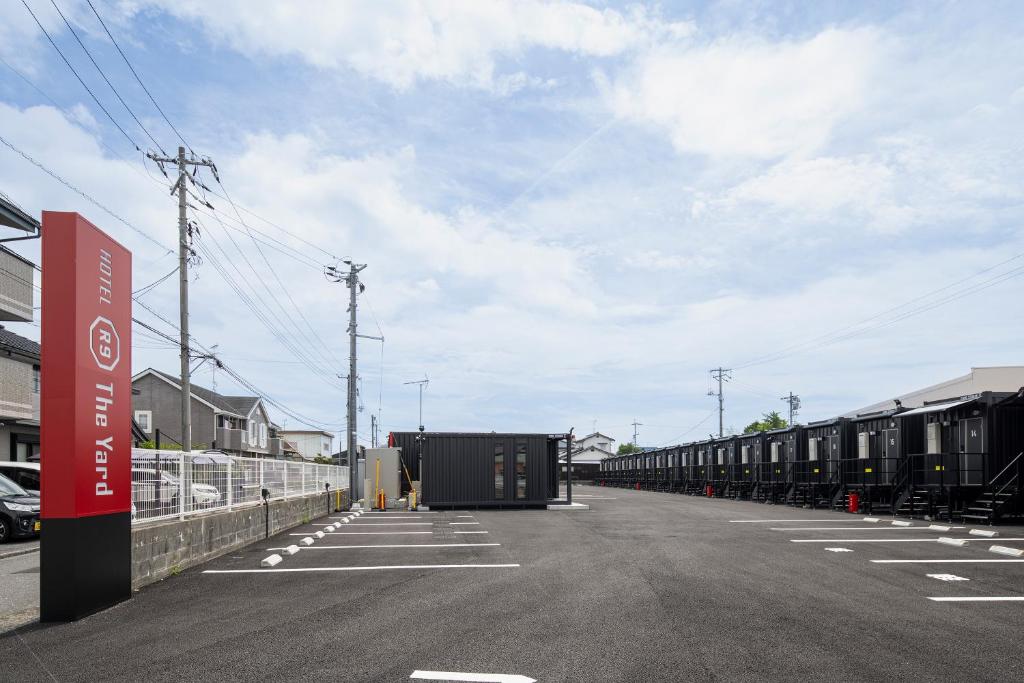 a parking lot with a long line of train cars at HOTEL R9 The Yard Iwakuni in Iwakuni