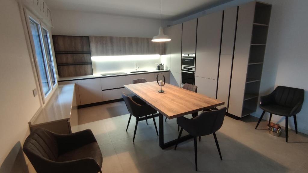 a small kitchen with a wooden table and chairs at BBConegliano Borlini in Conegliano