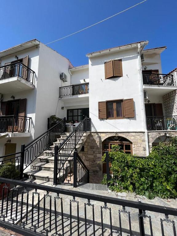 a large white building with stairs in front of it at Samos - Kokkari - Eirini's Studios in Kokkari