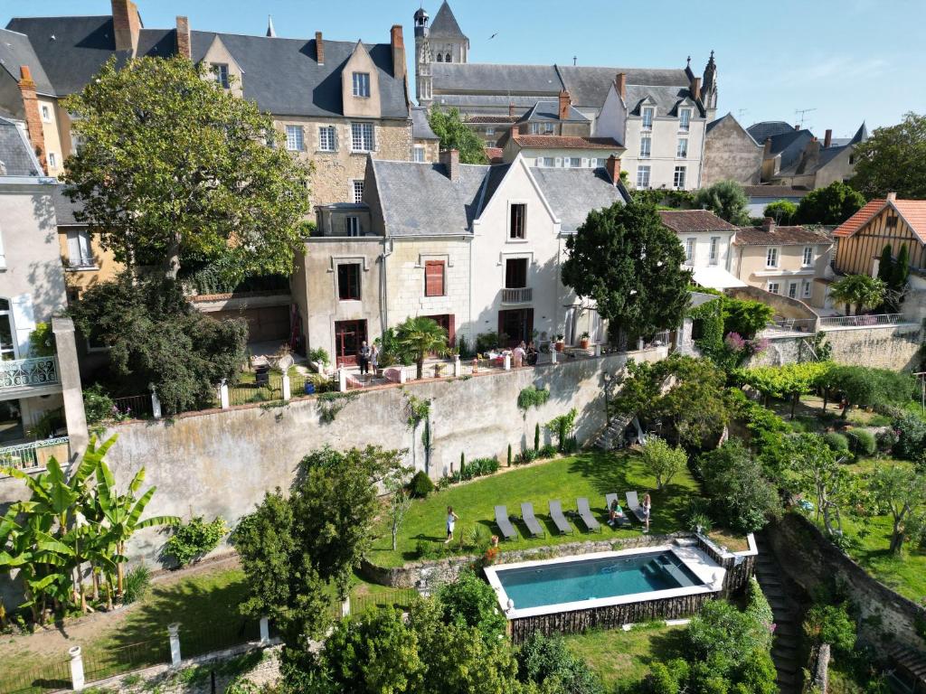a house with a swimming pool in the middle of a town at Au Petit Thouars in Thouars