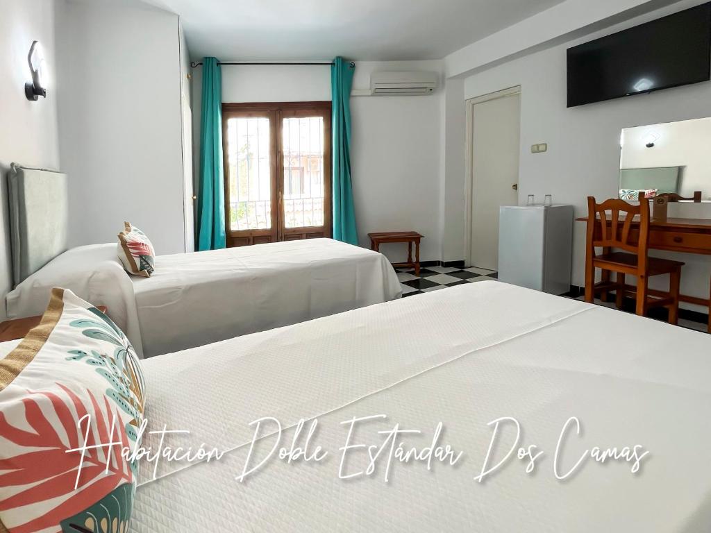 Posteľ alebo postele v izbe v ubytovaní Micaela Charming Hostal