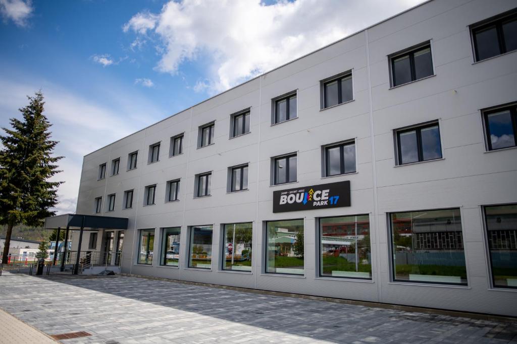 a white building with a sign that reads slow lease at Ubytovanie HAMAR 17 in Banská Bystrica
