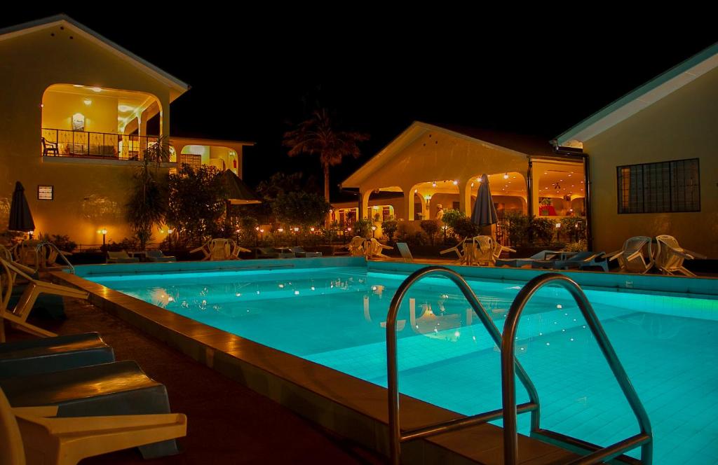 a swimming pool at a hotel at night at Springlands Hotel in Moshi