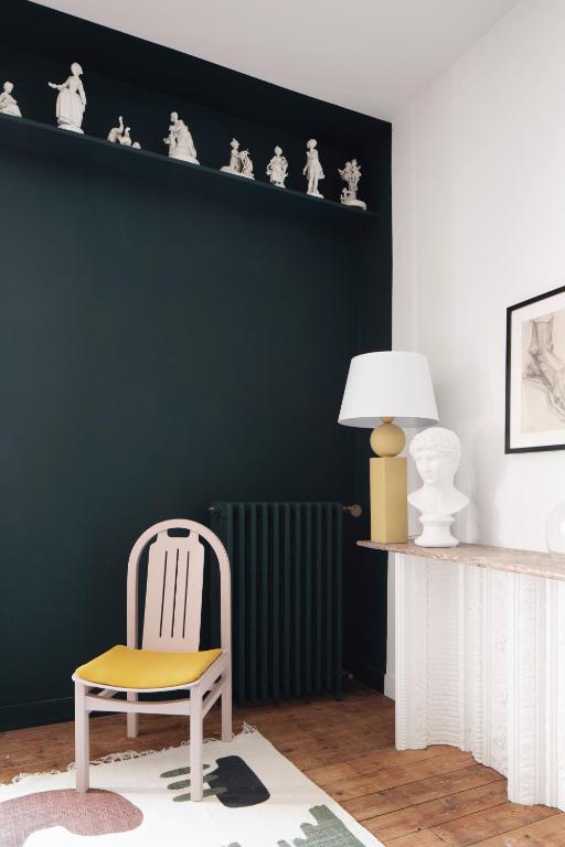 a living room with a chair and a radiator at Au Petit Thouars in Thouars