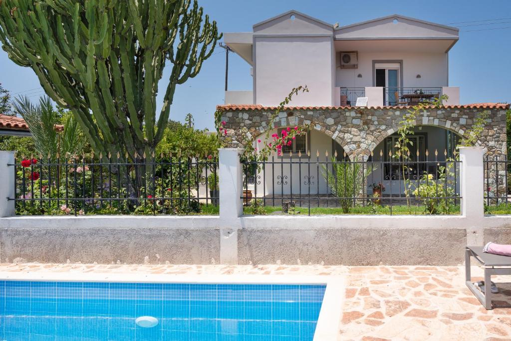 a villa with a swimming pool and a house at Elli's apartment 2 in Antimácheia