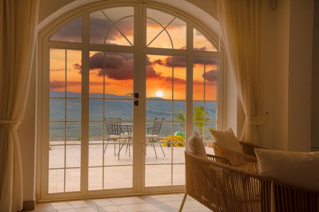 an open door to a patio with a view of the ocean at La Posta del Guardiano in Vieste