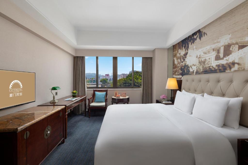 Postel nebo postele na pokoji v ubytování City Hotel Xiamen-Free Welcome Fruits