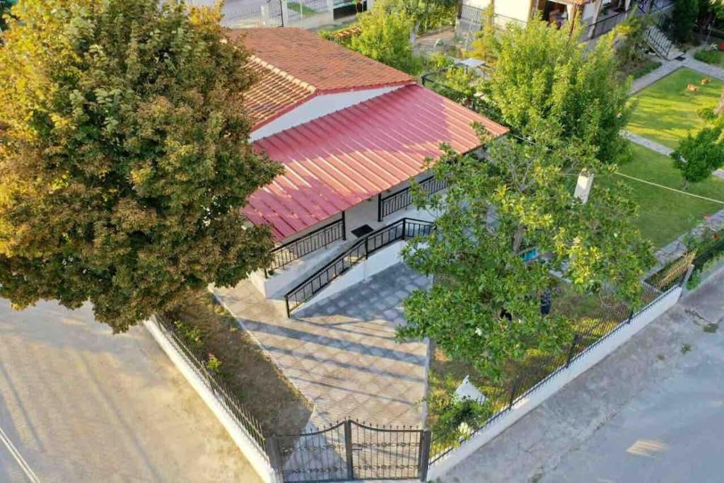an overhead view of a house with a red roof at Karipidis houses in Nea Iraklia