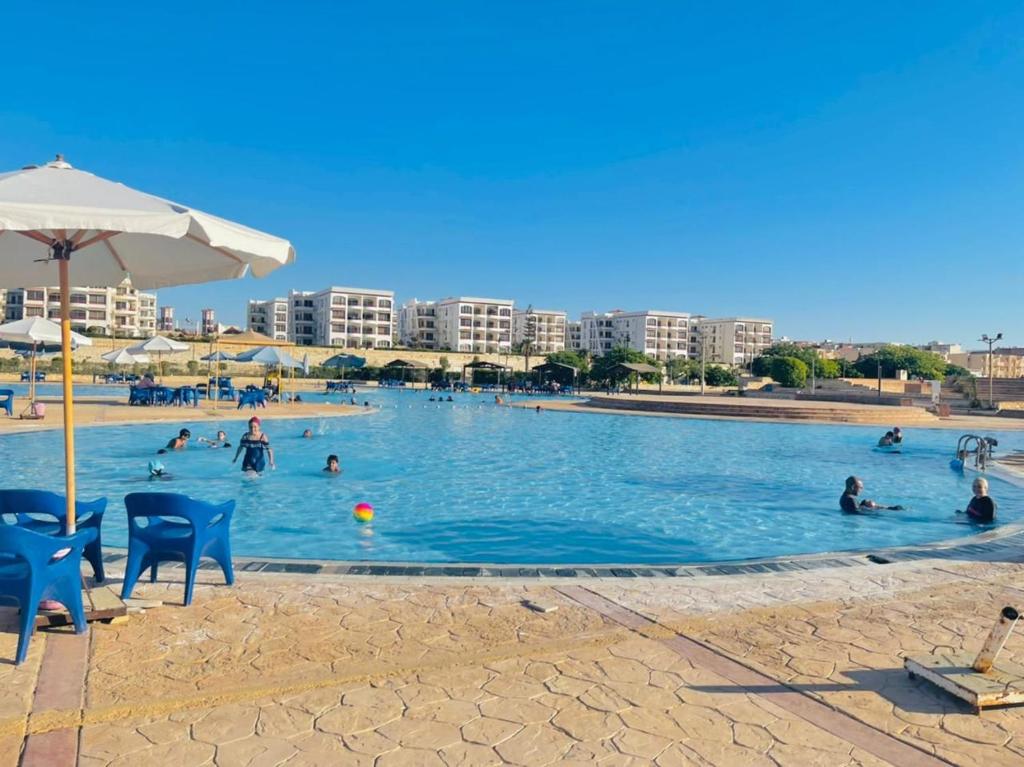 a large swimming pool with people in the water at 12 S in El Alamein