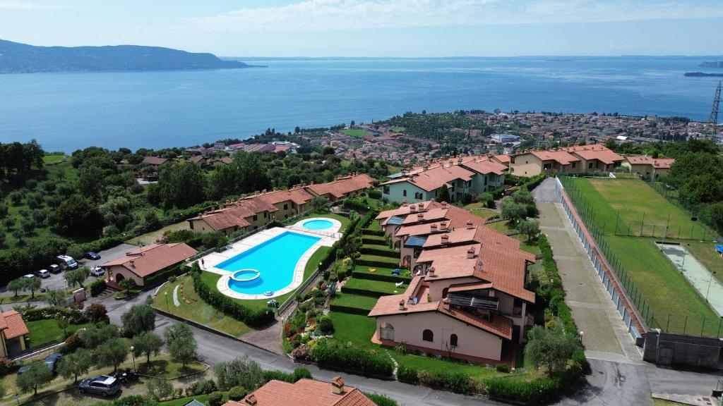 an aerial view of a resort with a swimming pool at BBQ & Pools GHH in Toscolano Maderno
