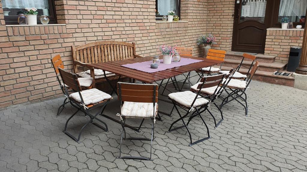 a wooden table and chairs on a patio at Friendly Home - Klinkerhof in Bornheim