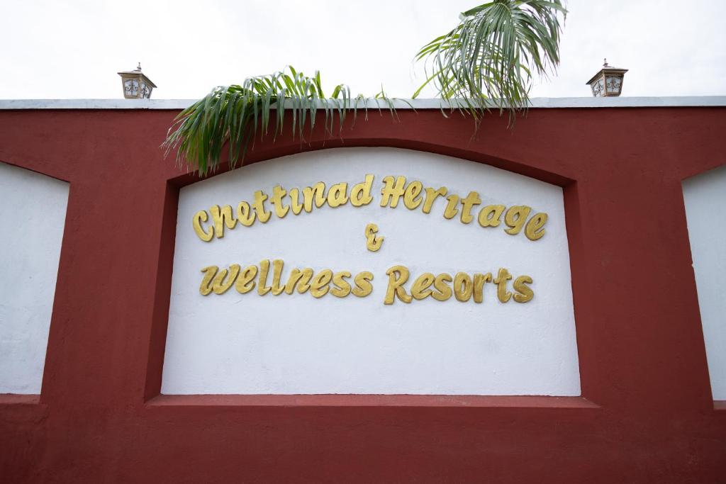 a sign for a wellness resort on top of a building at CHETTINAD HERITAGE WELLNESS RESORTS in Mithilaipatti