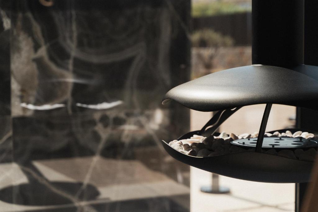 a black hat sitting on top of a window at Pnoe Breathing Life - Adults Only in Karteros