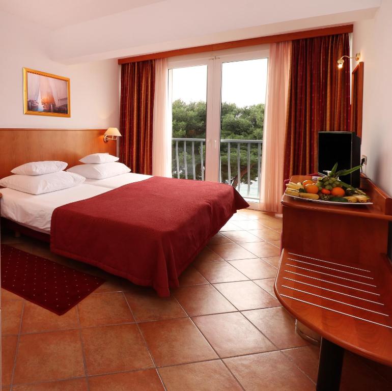 Postel nebo postele na pokoji v ubytování Hotel Zora