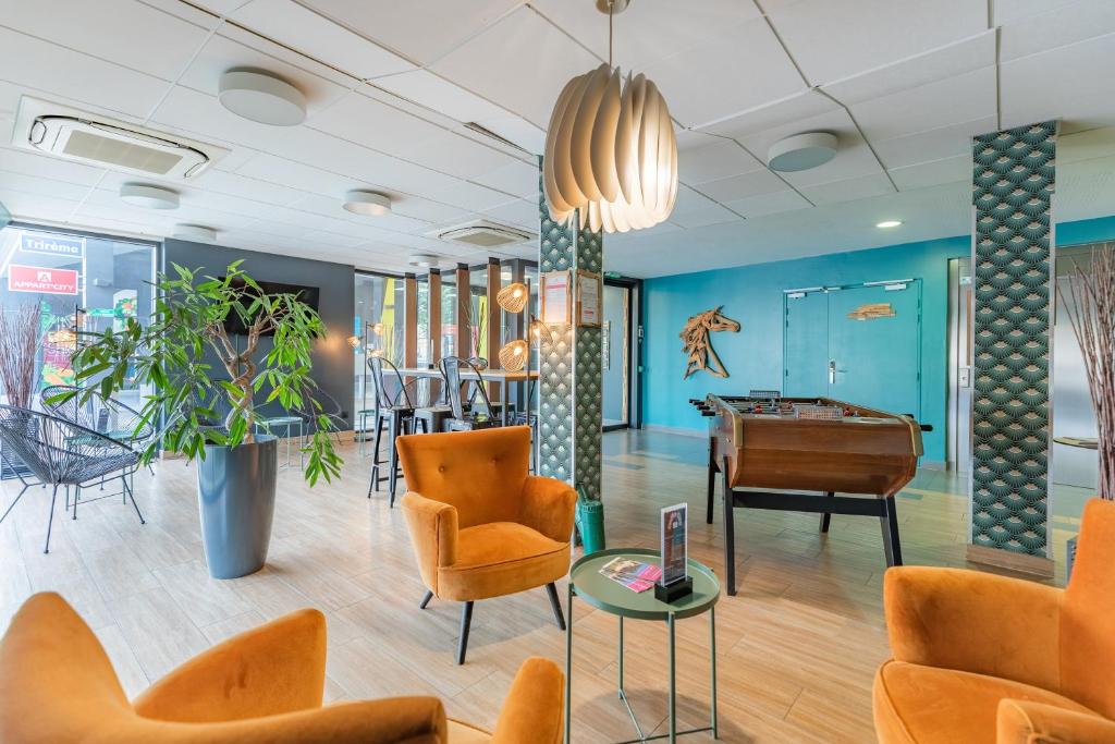 a lobby with a pool table and chairs at Appart'City Confort Bordeaux Chartrons in Bordeaux