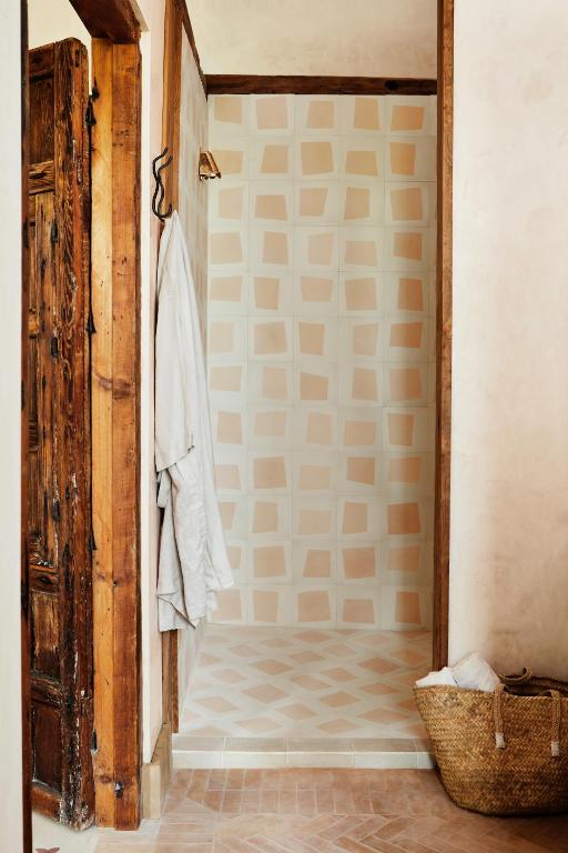 a bathroom with a walk in shower next to a door at Casa La Siesta in Vejer de la Frontera