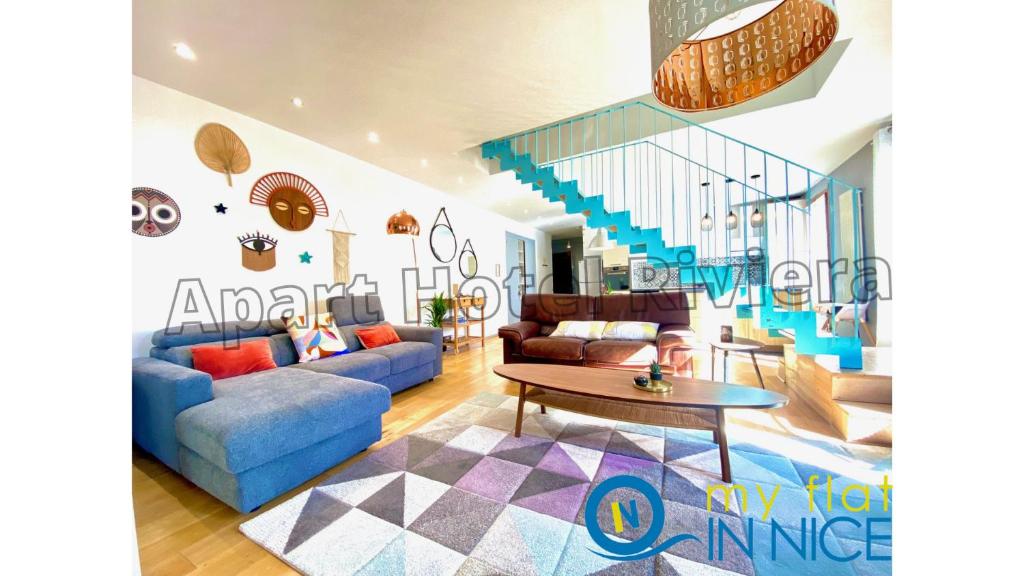 a living room with a blue couch and a staircase at ApartHotel Riviera Nice Côte d'Azur - Old Port - Amazing AC Duplex 3 bedrooms 2 bathrooms- DUPLEX MAISON DU PORT in Nice