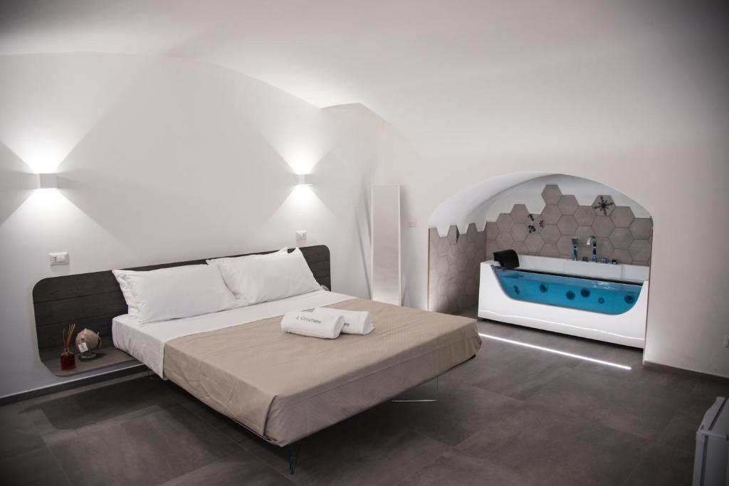 a bedroom with a bed and a bath tub at Il Cocchiere in Palagianello