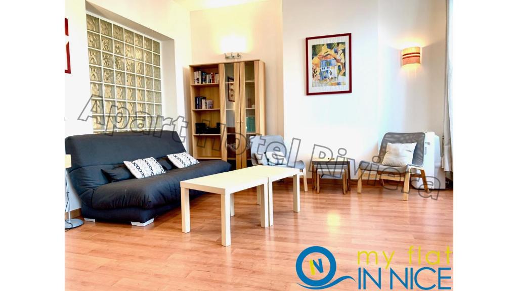 a living room with a couch and a table at ApartHotel Riviera - Liberte 1 - Grimaldi Promenade des Anglais 5mn - Supérieur 2 chambres AC - Emplacement Exceptionnel in Nice