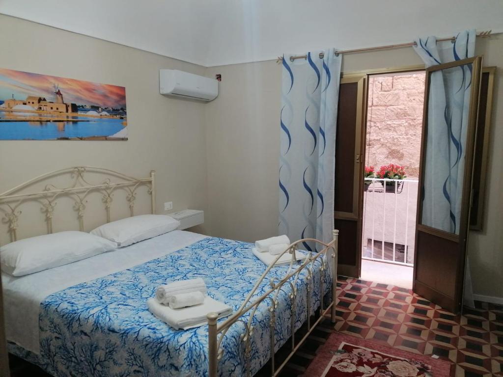 ein Schlafzimmer mit einem Bett mit zwei Handtüchern darauf in der Unterkunft La Cocorita in Trapani