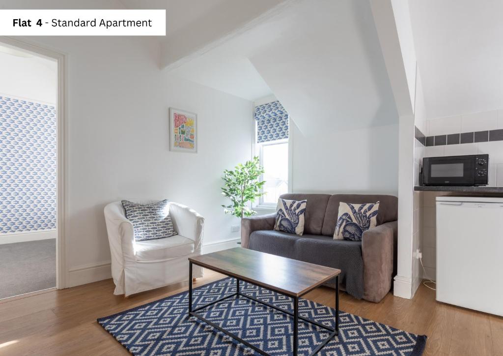 a living room with a couch and a coffee table at The Chymes Holiday Flats in Lytham St Annes