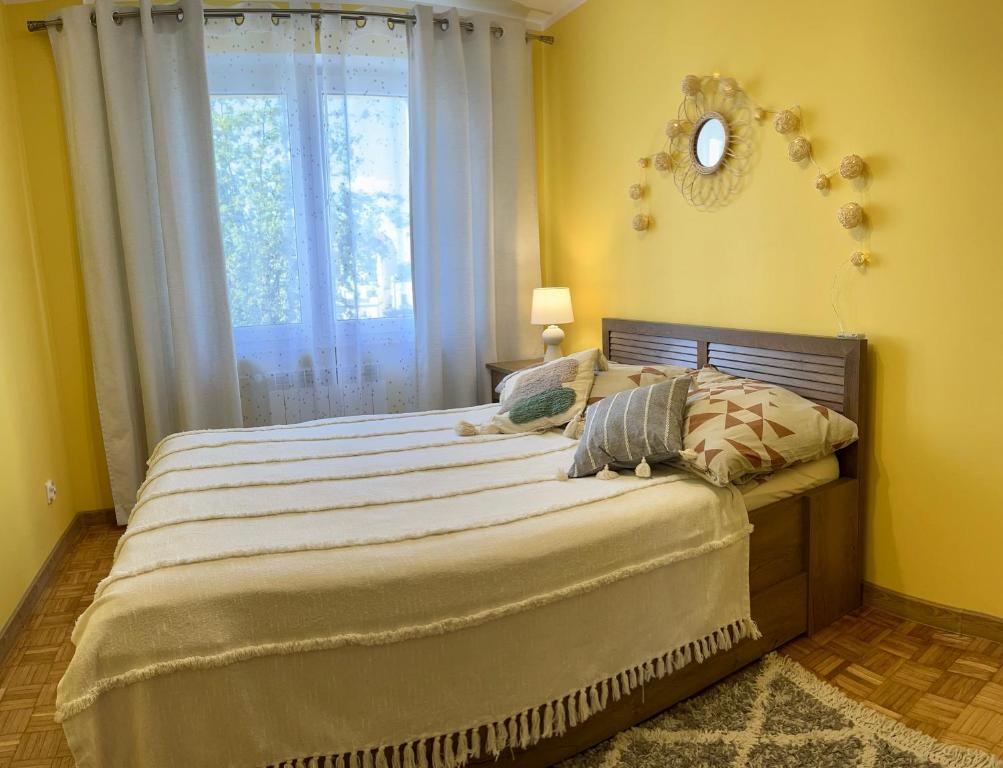 a bedroom with a large bed with a window at Apartament Omega I in Giżycko