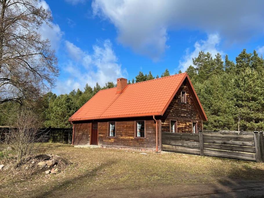 a house with an orange roof and a fence at Siedlisko Żabickie 