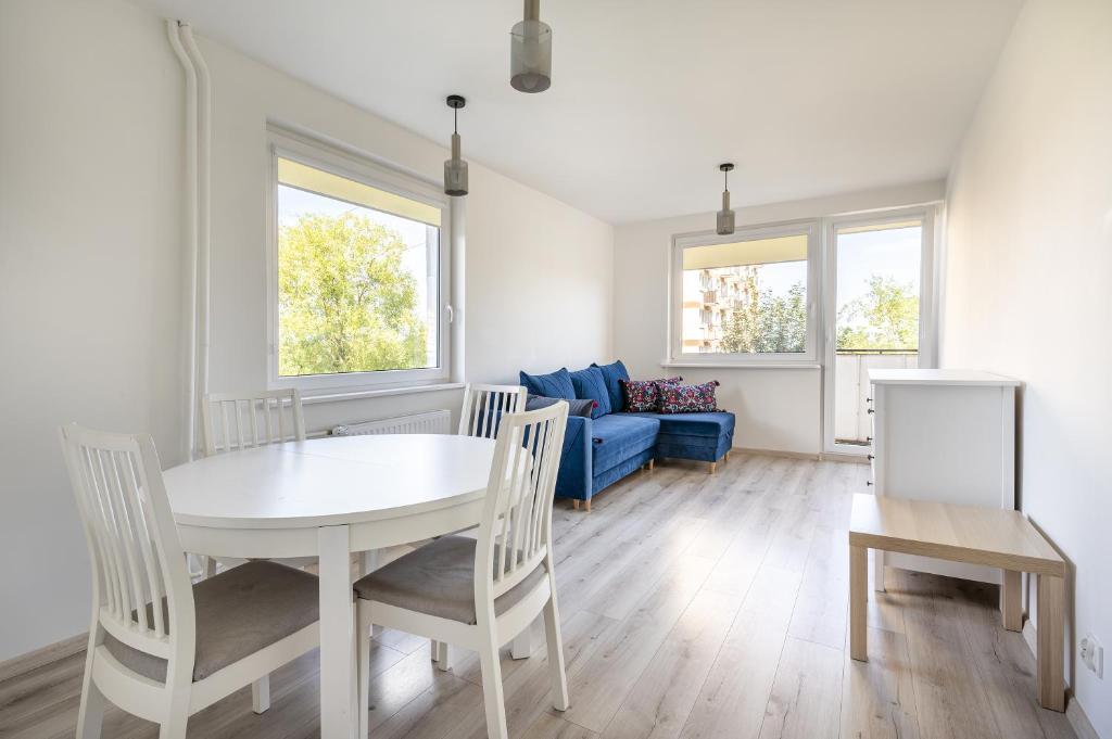 a dining room with a table and chairs and a couch at 01 Sopot - Apartament mieszkanie dla 6 osób in Sopot