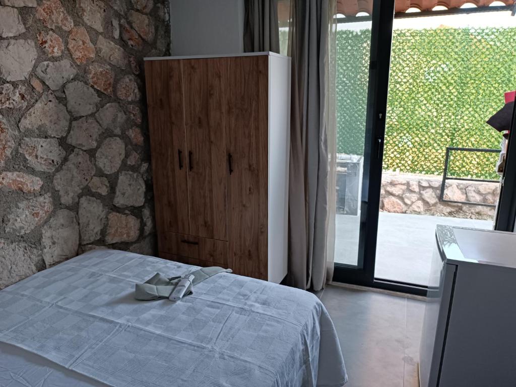 a bedroom with a bed and a large window at Taş oda in Kas