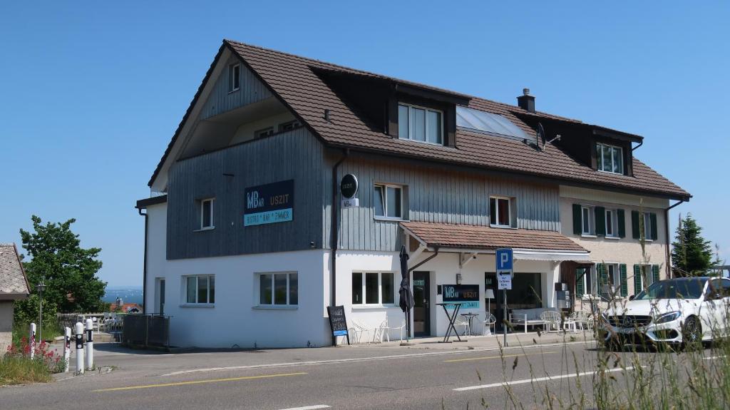 a large building with a brown roof at MBar in Altnau