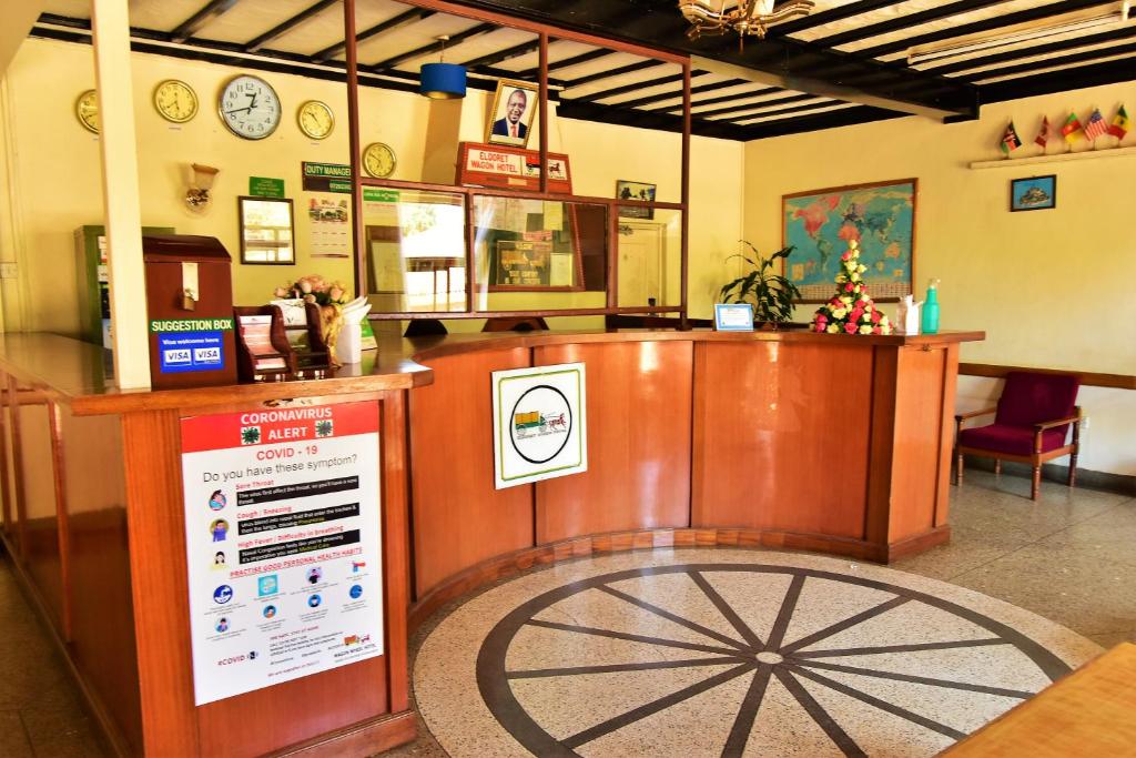 a fast food restaurant with a counter with a cash register at Wagon Wheel Hotel Eldoret in Eldoret