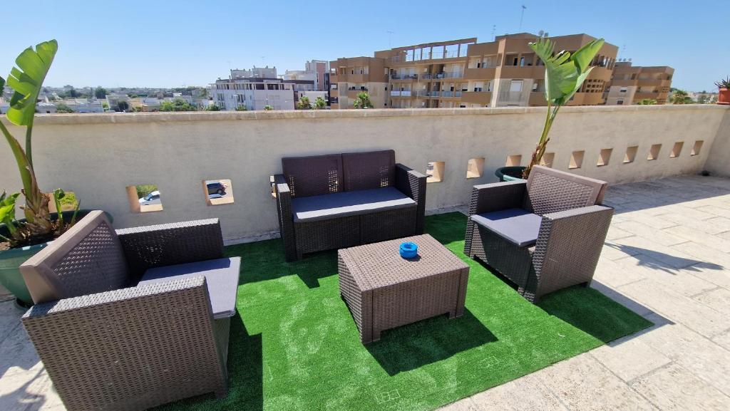 a patio with chairs and tables on a roof at "ELLE home" ATTICO panoramico in Lecce