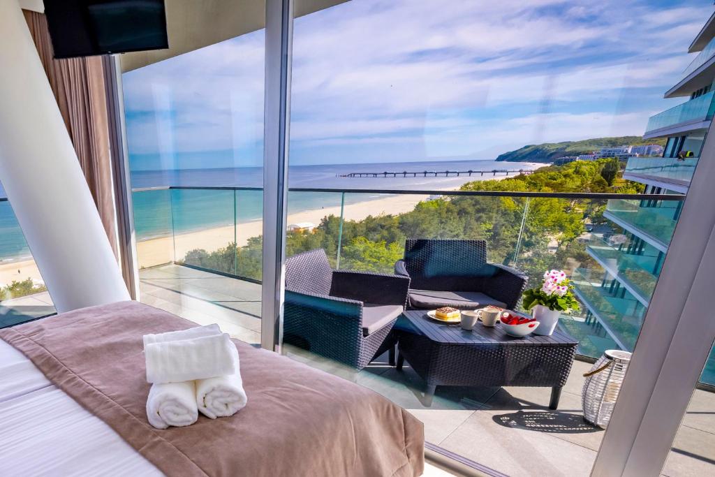 a bedroom with a bed and a view of the ocean at WAVE private apartment - Fancy Sunset in Międzyzdroje