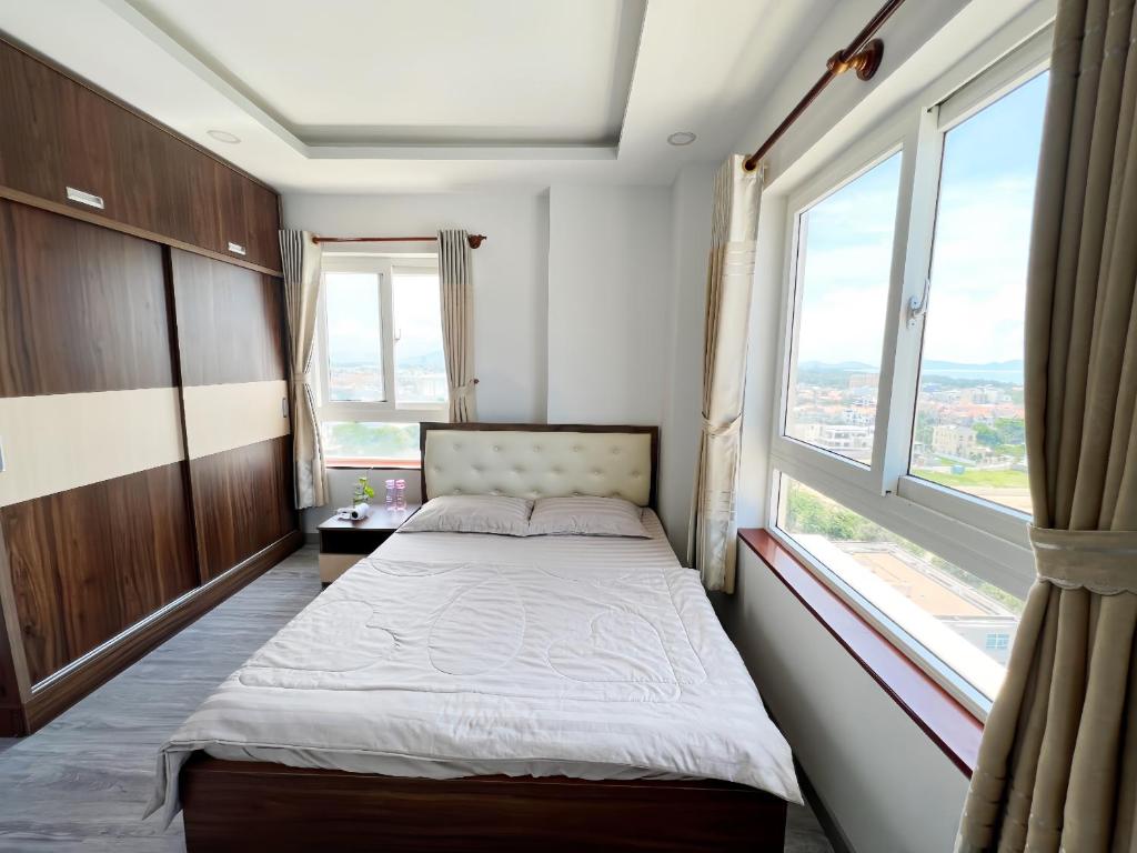 a bedroom with a bed and a large window at Ngọc Duyên Homestay- Central Vung Tau, near Lotte Mart in Vung Tau
