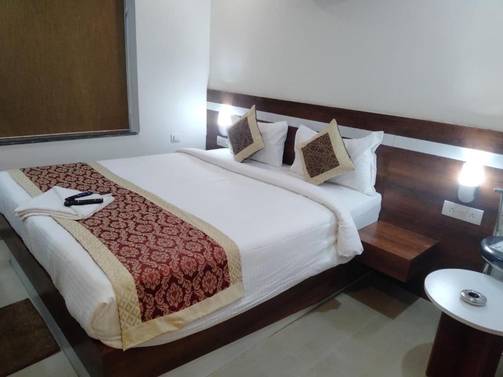 Postel nebo postele na pokoji v ubytování HOTEL SJ PREMIUM
