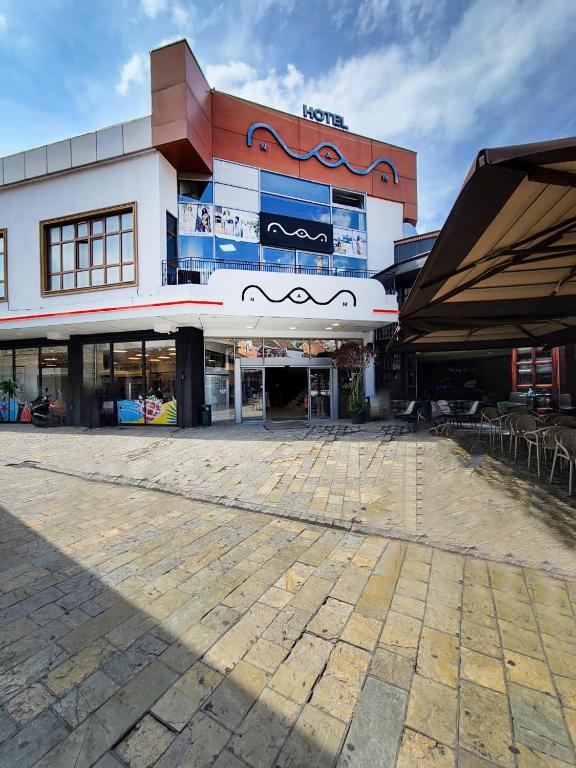a large building with a parking lot in front of it at Nam Hotel in Prizren