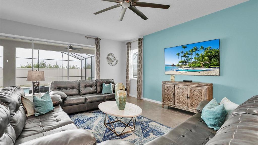a living room with couches and a ceiling fan at 1840 Caribbean View in Kissimmee